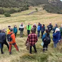 group of people talking on hill