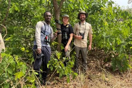 Three people in a tropical forest