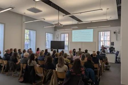 People sitting in rows in classroom
