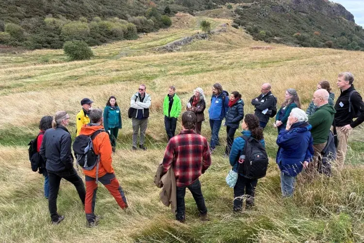 group of people talking on hill