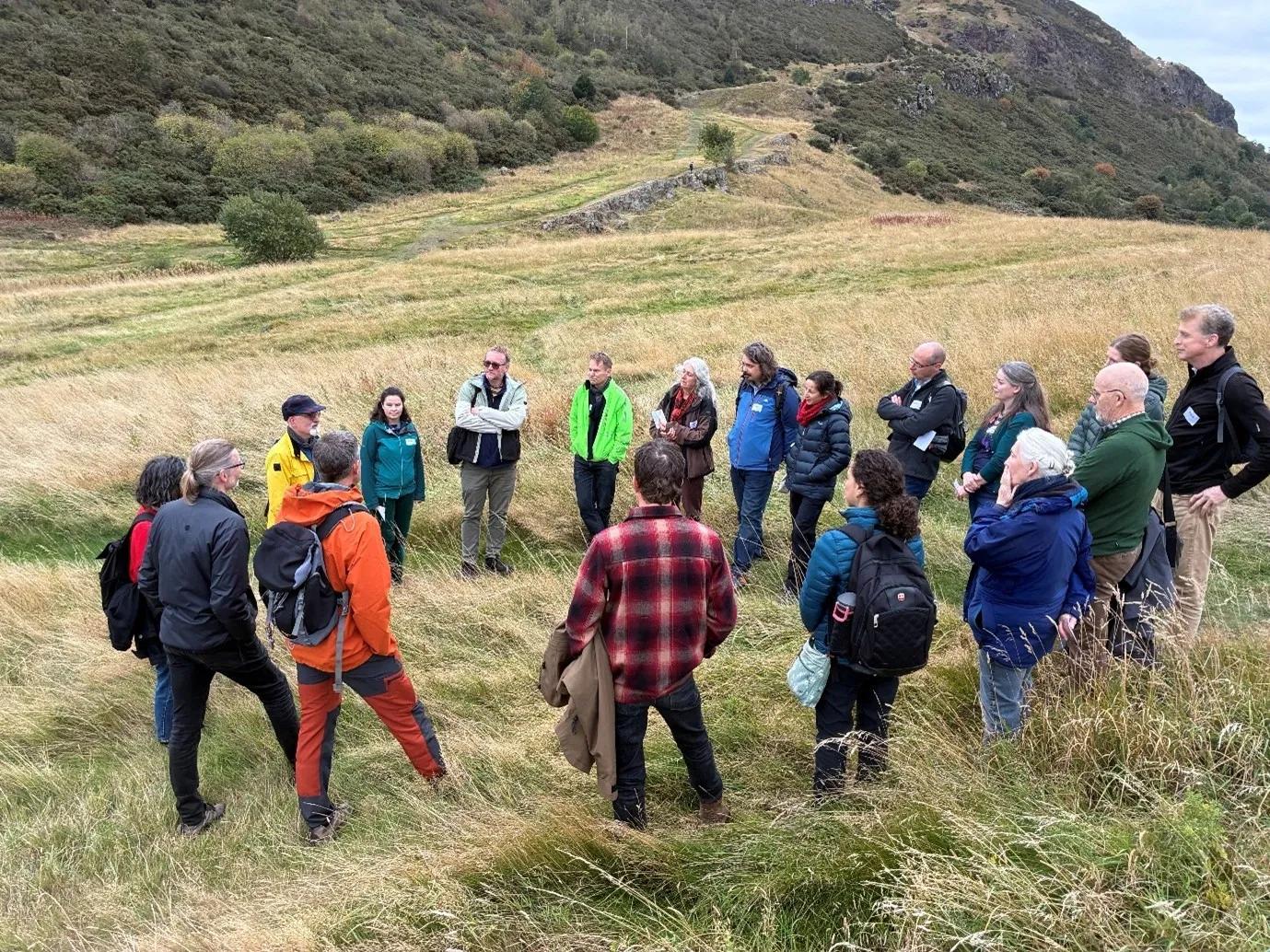 group of people talking on hill